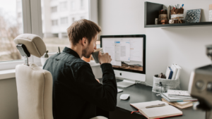 man sipping coffee at his desk working on business branding